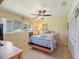 Bright bedroom with ceiling fan, window and large bed with unique quilt at 2673 Clubhouse S Dr, Clearwater, FL 33761