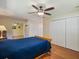 Comfortable bedroom with hardwood floors, closet space, and ceiling fan at 2673 Clubhouse S Dr, Clearwater, FL 33761