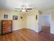 Bright bedroom with wood floors, closet space, and a ceiling fan at 2673 Clubhouse S Dr, Clearwater, FL 33761