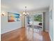 Well-lit dining room with a large window that looks out onto the front porch and yard at 2673 Clubhouse S Dr, Clearwater, FL 33761
