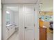 Hallway leading to bathroom with vanity, toilet, and shower/tub combination at 2673 Clubhouse S Dr, Clearwater, FL 33761