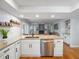 Kitchen with stainless appliances, granite counters, and bar seating overlooking the spacious living room at 2673 Clubhouse S Dr, Clearwater, FL 33761