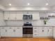 Updated kitchen with stainless appliances, granite counters, and ample white cabinetry at 2673 Clubhouse S Dr, Clearwater, FL 33761
