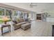 Bright sunroom with neutral tile flooring, a ceiling fan, and views of the backyard at 2673 Clubhouse S Dr, Clearwater, FL 33761