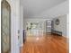 Open-concept living room features hardwood floors and access to the backyard at 2673 Clubhouse S Dr, Clearwater, FL 33761