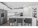 Modern kitchen featuring an island, stainless appliances, white cabinets, and pendant lighting, perfect for culinary enthusiasts at 29152 Coral Harbour Dr, Englewood, FL 34223