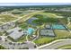 Aerial view of a community center with tennis courts and pool at 29356 Ginnetto Dr, Wesley Chapel, FL 33543