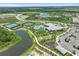An aerial view of community amenities, including tennis courts, swimming pool, clubhouse, and beautiful landscaping at 29356 Ginnetto Dr, Wesley Chapel, FL 33543