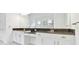 Bright bathroom featuring double vanities with dark countertops and white cabinets at 29356 Ginnetto Dr, Wesley Chapel, FL 33543