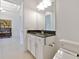 Bright bathroom with marble countertops, modern toilet, and white cabinets at 29356 Ginnetto Dr, Wesley Chapel, FL 33543