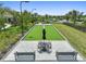 A beautifully designed bocce ball court with comfortable seating, offering a relaxing outdoor activity space at 29356 Ginnetto Dr, Wesley Chapel, FL 33543