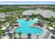 A luxurious community pool with ample seating, surrounded by palm trees, offering a resort-style experience for residents at 29356 Ginnetto Dr, Wesley Chapel, FL 33543
