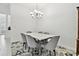 Elegant dining room with a modern chandelier and seating for six at 29356 Ginnetto Dr, Wesley Chapel, FL 33543