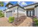 Beautiful property with well-manicured landscaping, a paver walkway, and gray garage door at 29356 Ginnetto Dr, Wesley Chapel, FL 33543