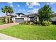 Charming single-Gathering home with a lush green lawn and a two-car garage at 29356 Ginnetto Dr, Wesley Chapel, FL 33543