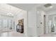 Grand foyer with decorative glass front doors, chandelier, high ceilings, and classic architectural details at 29356 Ginnetto Dr, Wesley Chapel, FL 33543