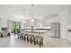 Bright kitchen features white cabinetry, stainless steel appliances, an island with seating, and views of the backyard at 29356 Ginnetto Dr, Wesley Chapel, FL 33543