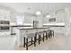 Modern kitchen with white cabinets, stainless steel appliances, a large island with seating, and updated lighting at 29356 Ginnetto Dr, Wesley Chapel, FL 33543