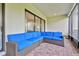 Comfortable screened lanai with brick flooring and a cozy blue sectional seating area at 29356 Ginnetto Dr, Wesley Chapel, FL 33543