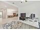 Open office space with modern furniture and a view into the dining area at 29356 Ginnetto Dr, Wesley Chapel, FL 33543