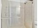 Modern bathroom featuring a glass-enclosed shower with tile surround and updated hardware at 29356 Ginnetto Dr, Wesley Chapel, FL 33543