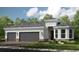 Beautiful single-story home with a three-car garage, stone accents, and a well-manicured lawn at 29936 Rusco Ct, Wesley Chapel, FL 33543