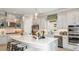 Modern kitchen featuring a large center island, stainless steel appliances, and stylish pendant lighting at 29936 Rusco Ct, Wesley Chapel, FL 33543