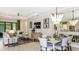 Open living area with dining table and chairs, sectional sofa and stylish decor at 29936 Rusco Ct, Wesley Chapel, FL 33543