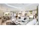 Bright open concept living room with contemporary furnishings and an open flow into the kitchen and dining area at 29936 Rusco Ct, Wesley Chapel, FL 33543