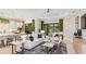 Bright living room with open concept design, stylish furniture, and access to the outdoor patio at 29936 Rusco Ct, Wesley Chapel, FL 33543