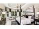 Elegant primary suite with a luxurious bed, chandelier, and large windows offering natural light at 29936 Rusco Ct, Wesley Chapel, FL 33543