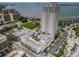 An aerial view of a modern high-rise apartment building featuring a resort-style pool and waterfront views at 331 Cleveland St # 402, Clearwater, FL 33755