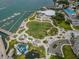 Aerial view of waterfront park featuring a playground, amphitheater, and a marina with docked boats at 331 Cleveland St # 402, Clearwater, FL 33755