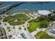 An aerial view of a park, waterfront, and amphitheater, with a marina filled with boats in the background at 331 Cleveland St # 402, Clearwater, FL 33755