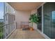Nice balcony with a seat and sliding glass doors featuring views of the bay and a potted palm tree at 331 Cleveland St # 402, Clearwater, FL 33755