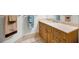 Bright bathroom featuring tile floors, a modern sink, a wood vanity, and neutral color scheme at 331 Cleveland St # 402, Clearwater, FL 33755