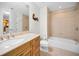 Well-lit bathroom featuring tile floors, a bathtub, a wood vanity, and a neutral color scheme at 331 Cleveland St # 402, Clearwater, FL 33755