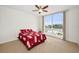 Bright bedroom with a large window offering city views, a ceiling fan, and neutral-toned carpet at 331 Cleveland St # 402, Clearwater, FL 33755