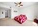 Bedroom with a ceiling fan, neutral-toned carpet, and adjoining access to the hallway and closet at 331 Cleveland St # 402, Clearwater, FL 33755