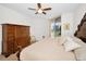 Bright bedroom featuring a ceiling fan, balcony access with city views, and a wooden armoire at 331 Cleveland St # 402, Clearwater, FL 33755