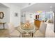 Inviting dining area with a glass table set for three, bright lighting, and an open floor plan at 331 Cleveland St # 402, Clearwater, FL 33755