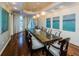 Elegant dining room with a large table, modern lighting, and views of the outside at 331 Cleveland St # 402, Clearwater, FL 33755