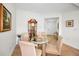 Charming dining area with seating for four, complemented by a decorative grandfather clock and elegant decor at 331 Cleveland St # 402, Clearwater, FL 33755