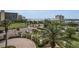 Scenic building view featuring tropical landscaping, parking and picturesque views of the bay and nearby city architecture at 331 Cleveland St # 402, Clearwater, FL 33755