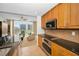 Modern kitchen features wooden cabinets, stainless steel appliances and a seamless flow into the living room at 331 Cleveland St # 402, Clearwater, FL 33755
