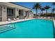 Large outdoor pool with crystal-clear water, lounge chairs, and meticulously maintained landscaping at 331 Cleveland St # 402, Clearwater, FL 33755