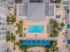 Aerial view of a sparkling pool, surrounded by palm trees and elegant architecture at 331 Cleveland St # 402, Clearwater, FL 33755