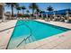 Large outdoor pool surrounded by comfortable lounge chairs and tables, perfect for relaxing at 331 Cleveland St # 402, Clearwater, FL 33755