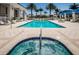 Outdoor pool and hot tub surrounded by luxurious seating, lush greenery, and pristine tile at 331 Cleveland St # 402, Clearwater, FL 33755