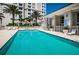 Gorgeous pool area with lounge chairs and pristine pool against a luxury tower at 331 Cleveland St # 402, Clearwater, FL 33755